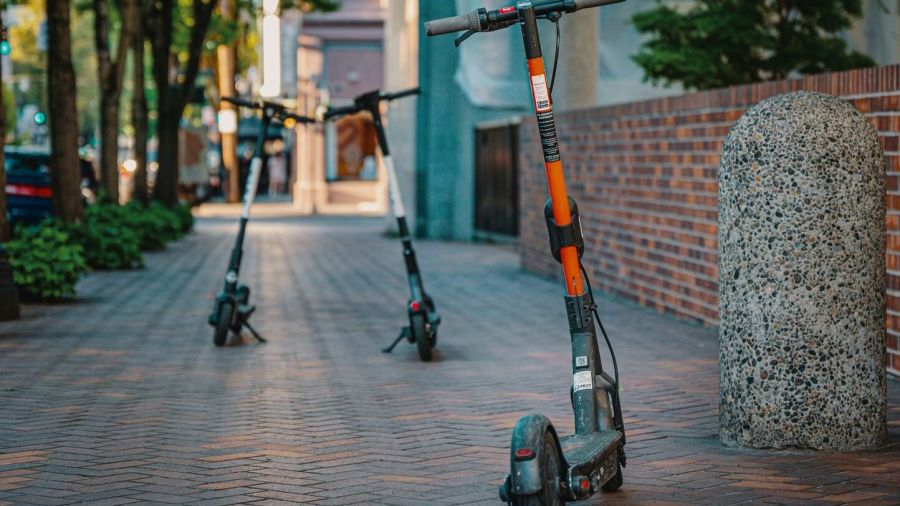 Electric scooters parked on a city sidewalk, embracing urban transportation and modern mobility.