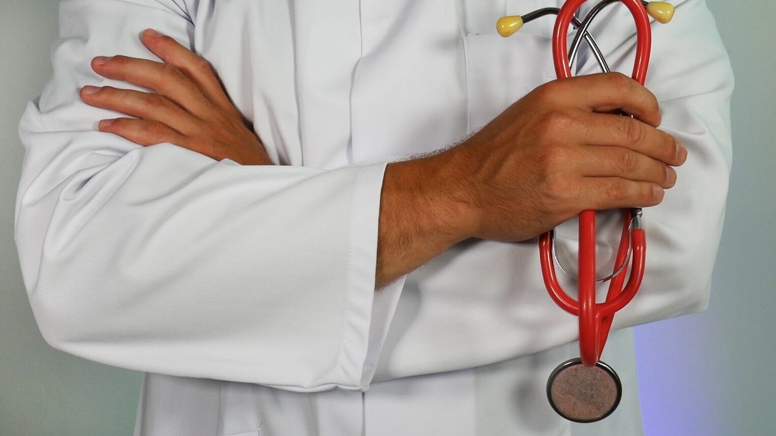 doctor holding red stethoscope