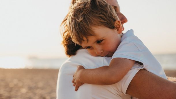 boy hugging woman