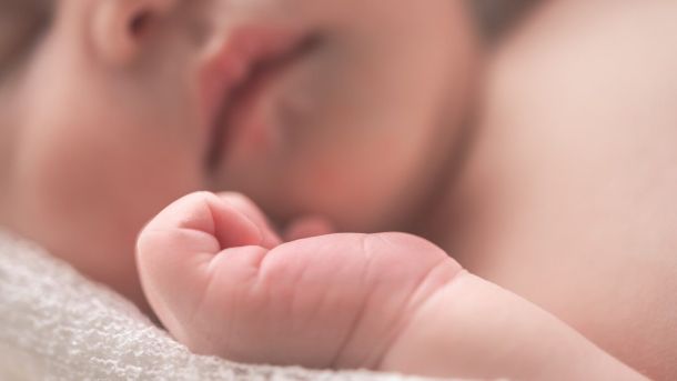 sleeping baby on white textile