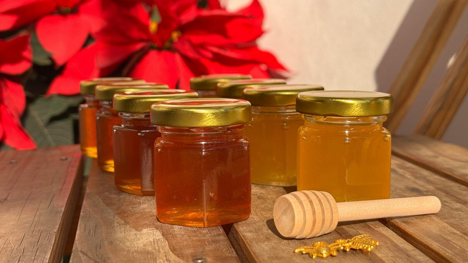 A wooden table topped with jars of honey