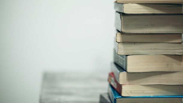 assorted books on wooden table