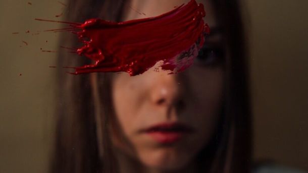 a woman with red paint on her face