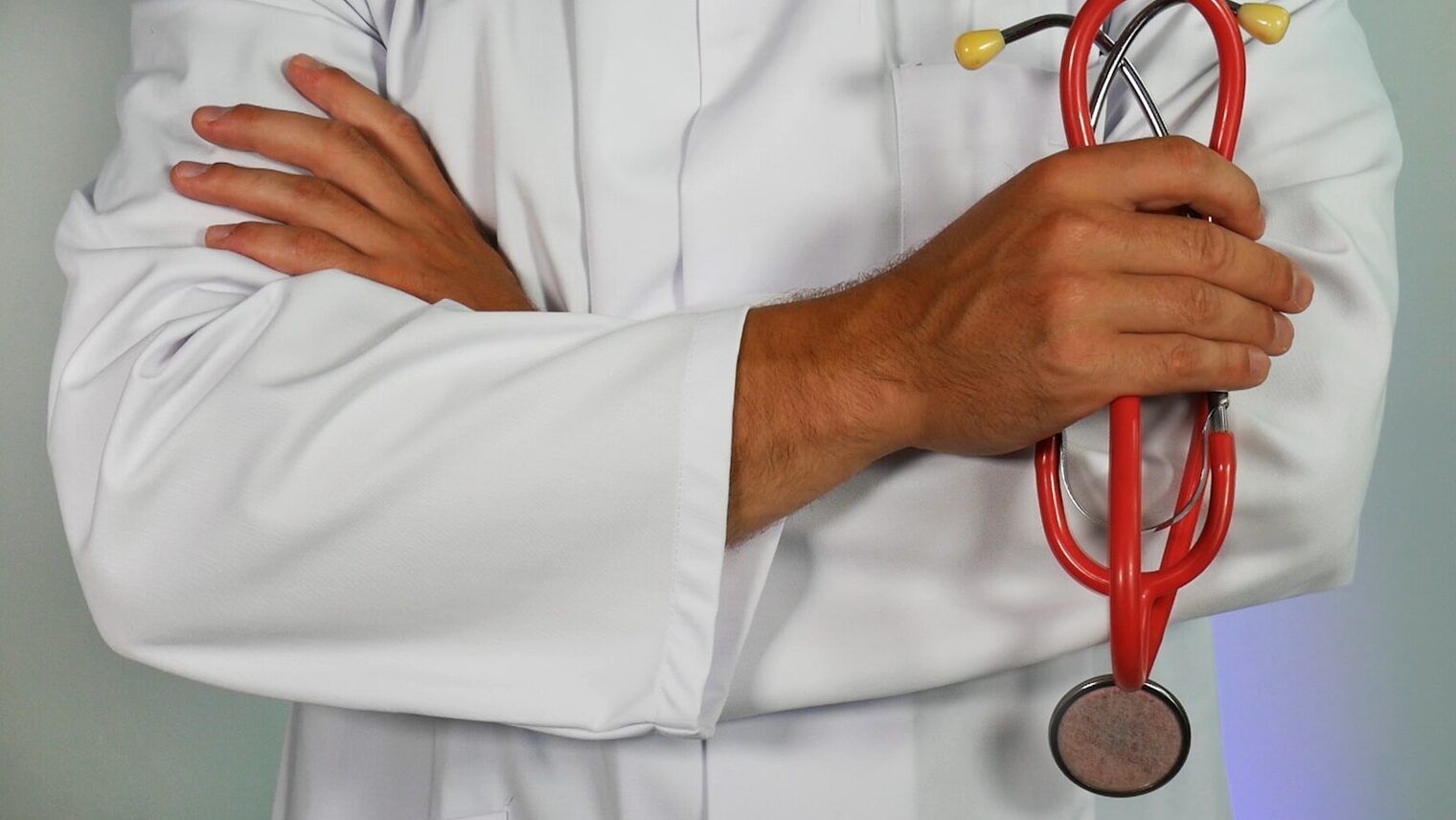 doctor holding red stethoscope