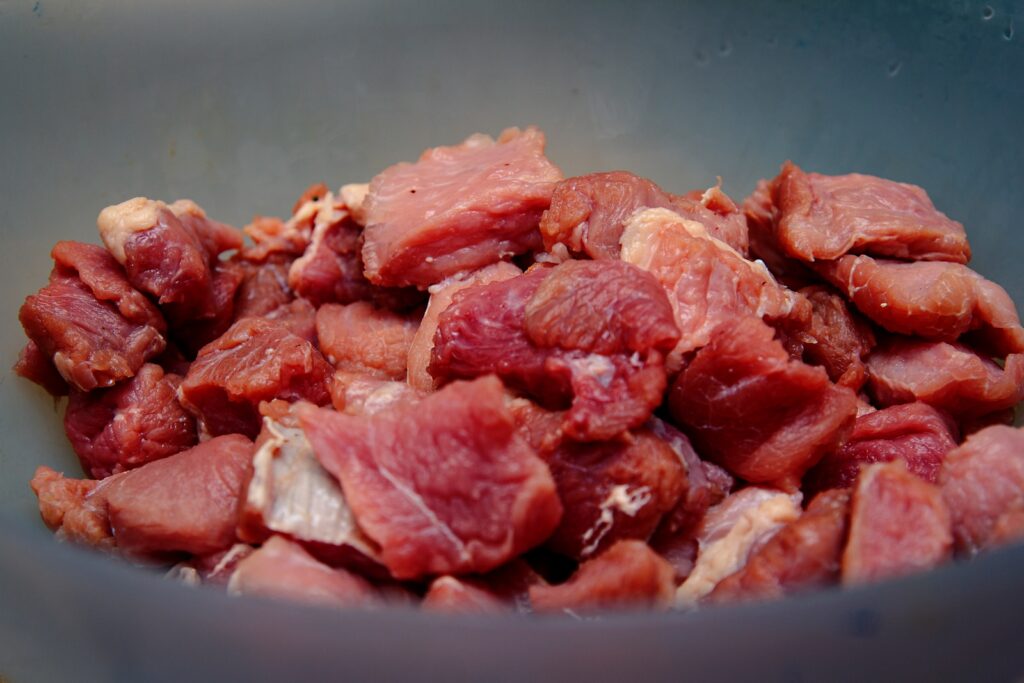 raw meat on blue ceramic bowl