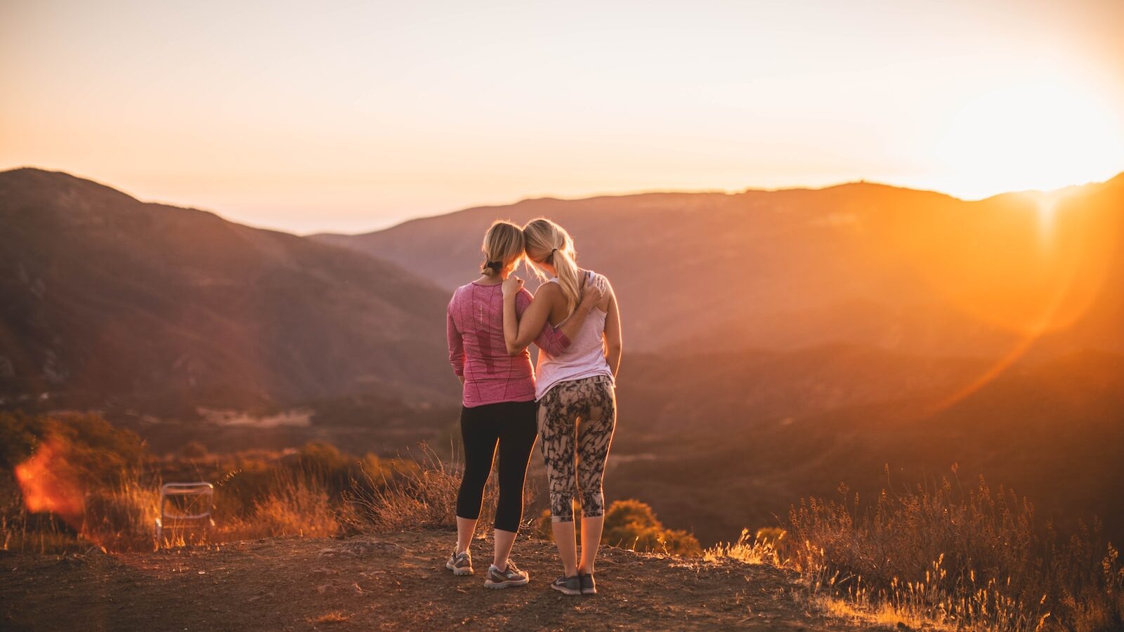 two women standing on moutain