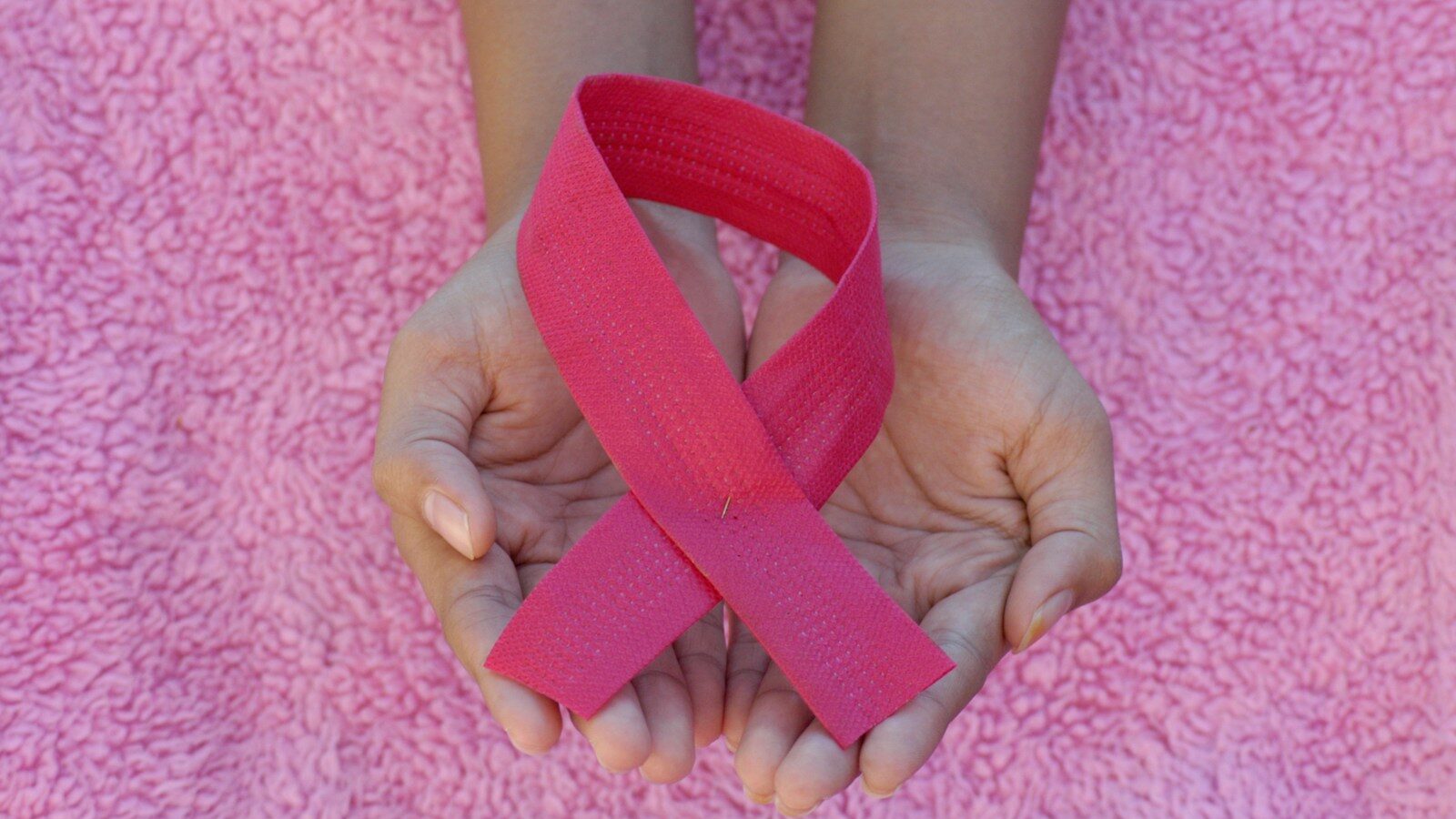 person with pink band on her left hand