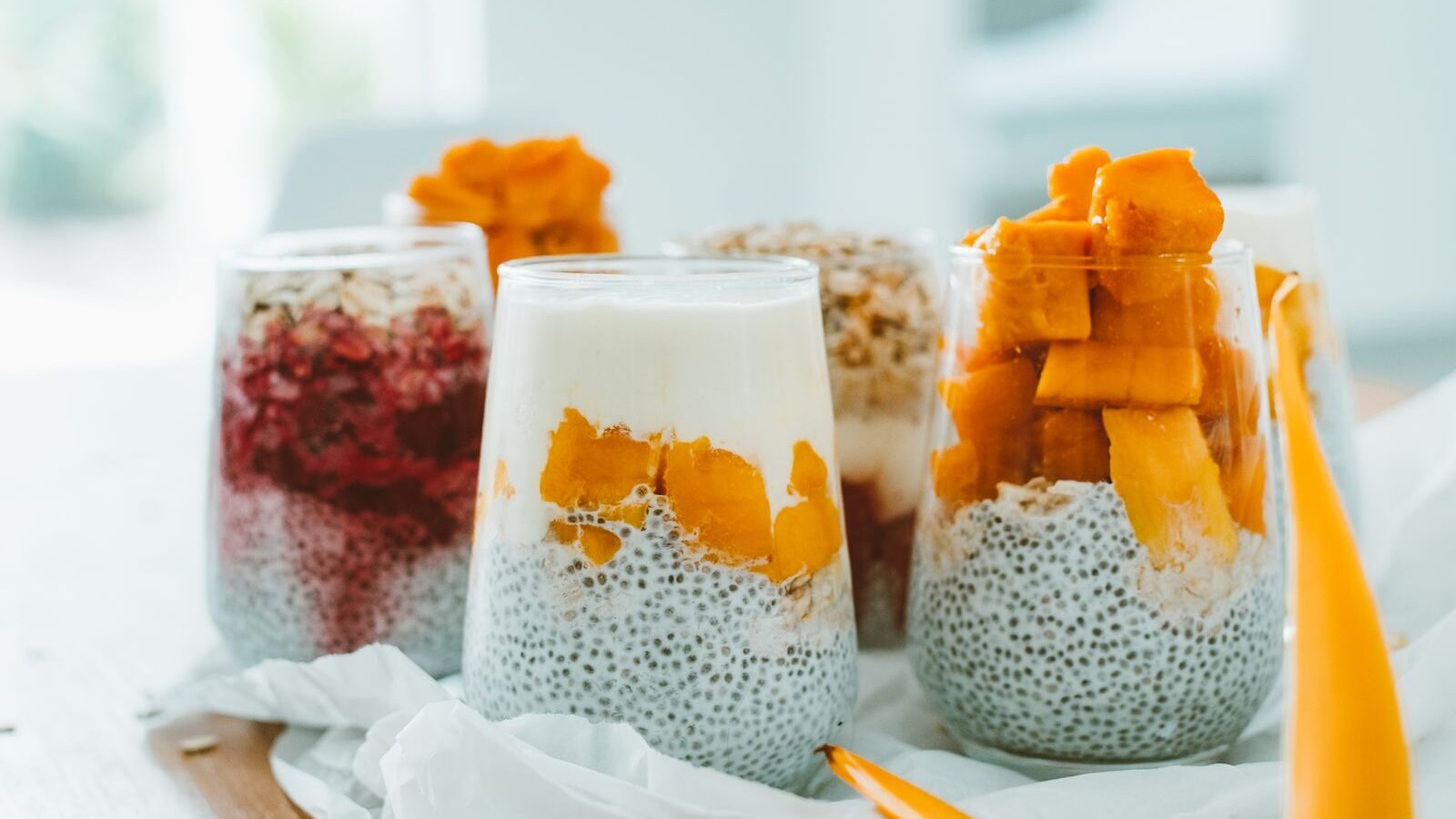 Delicious chia pudding parfaits topped with vibrant, fresh fruits and yogurt.