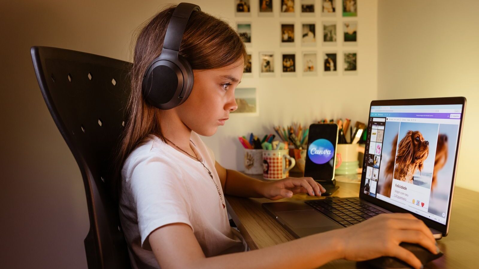A young girl wearing headphones is focused on her laptop, engaging with educational content at her desk.