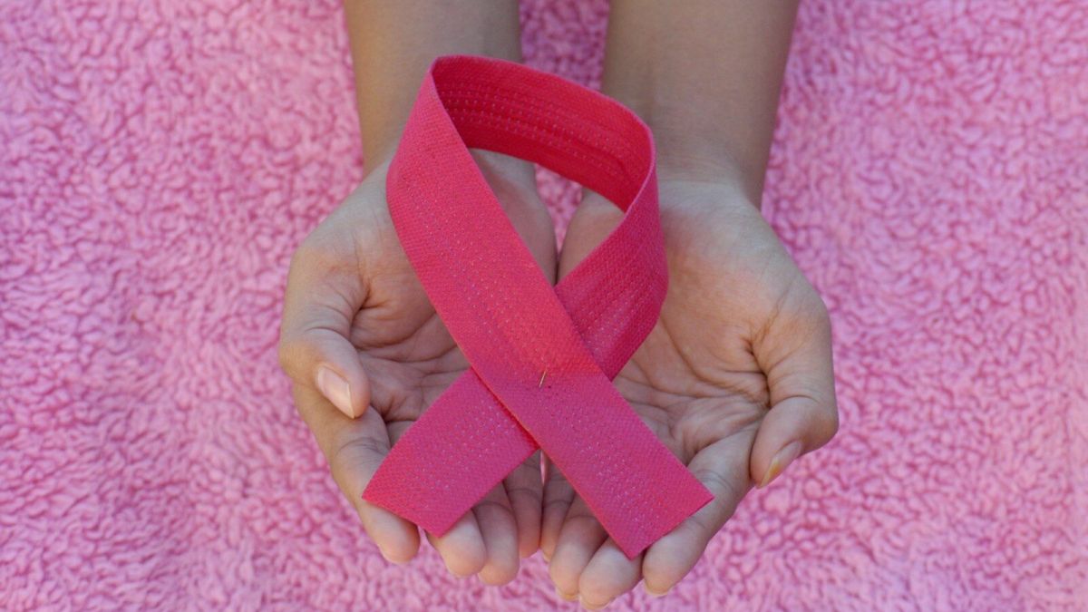 person with pink band on her left hand