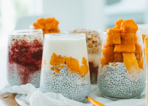 Delicious chia pudding parfaits topped with vibrant, fresh fruits and yogurt.