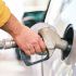 a man pumping gas into his car at a gas station