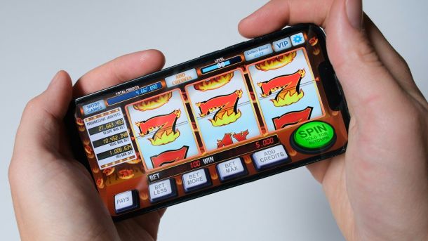 Someone is playing a mobile slot machine game.